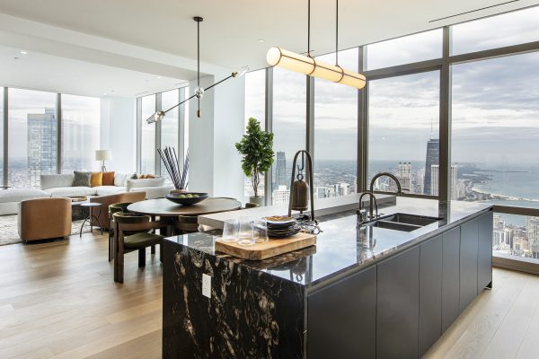 Kitchen and living area within the interior of a St. Regis Chicago penthouse