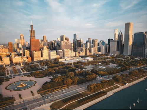 Lakeshore East planned community seen from above with bits of Lake Michigan showing next to Millennium and Grant Parks and other cityscape buildings of Chicago in the background